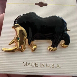 Vintage Black and Gold Rhinoceros Brooch with green sparkling eye